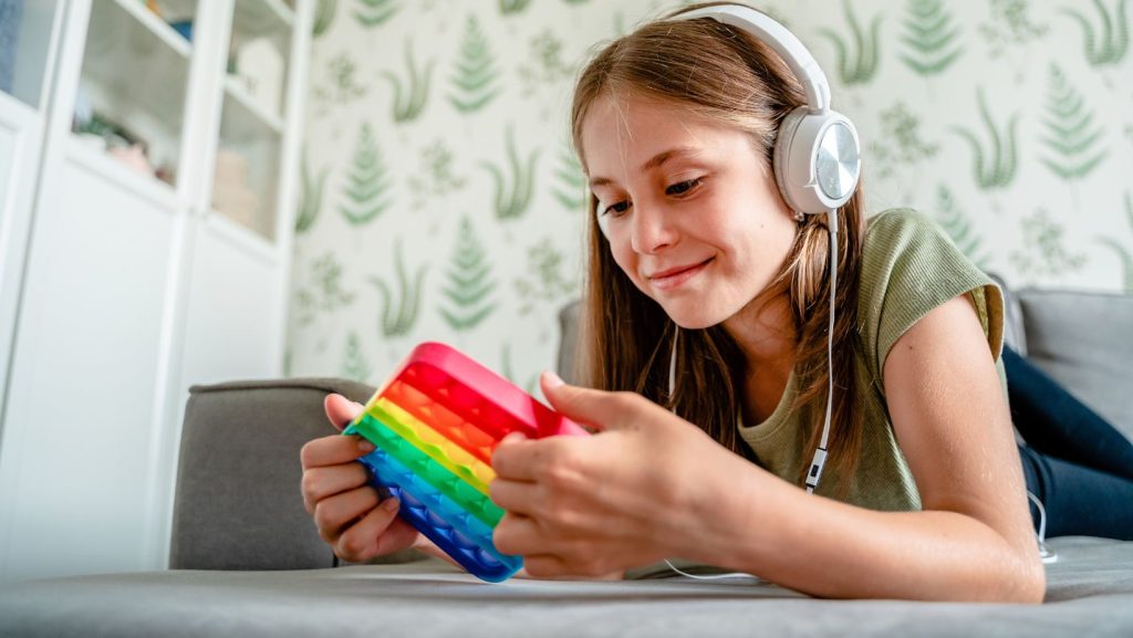 a student with headphones on and fidget toy