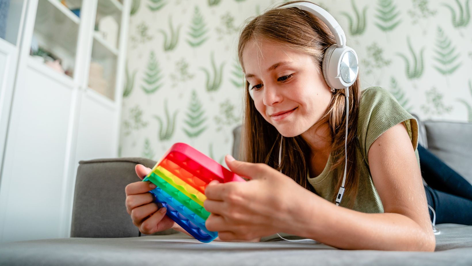 a student with headphones on and fidget toy